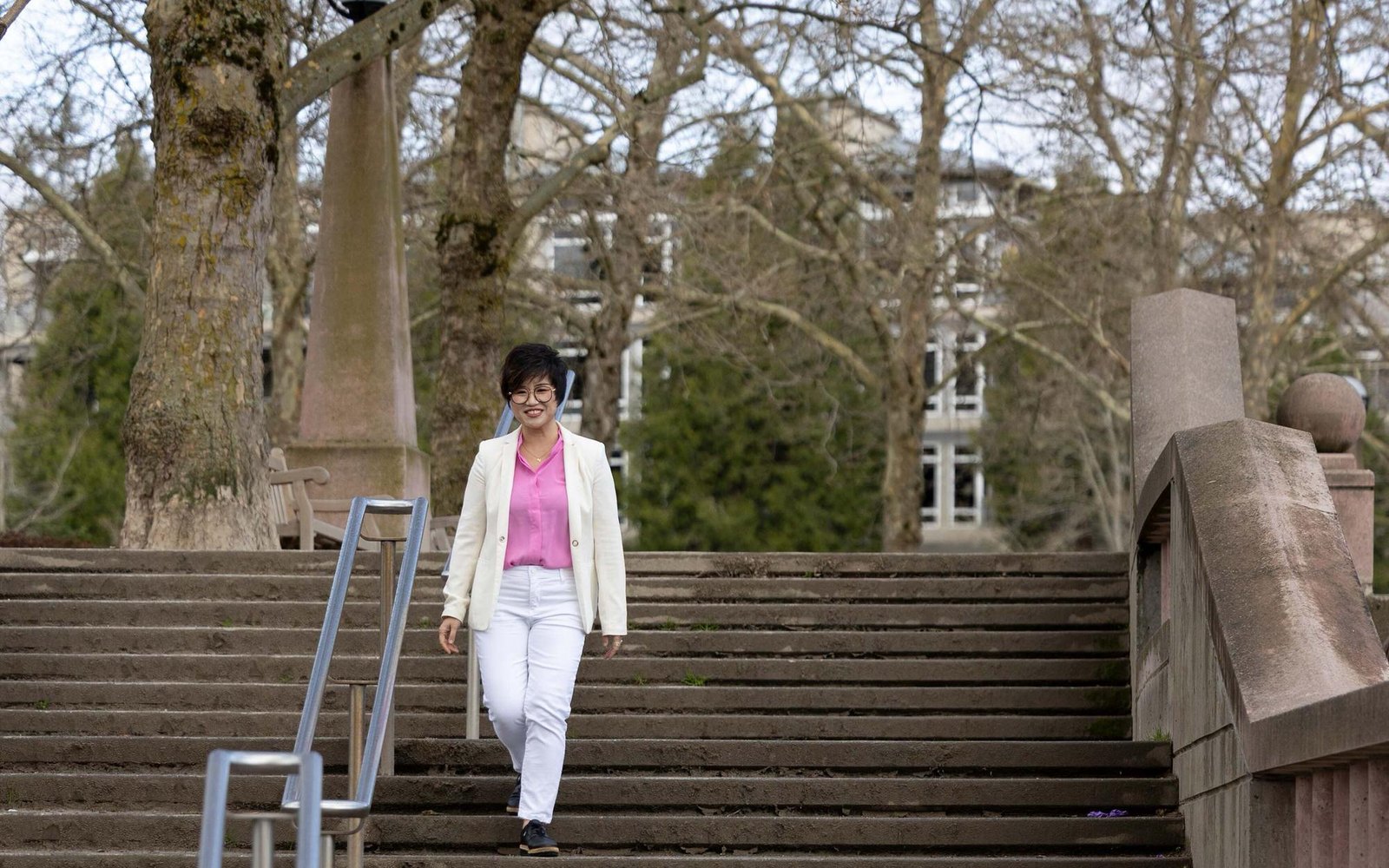 Maggie Sun walking through a Bellevue park on the way to a property tour
