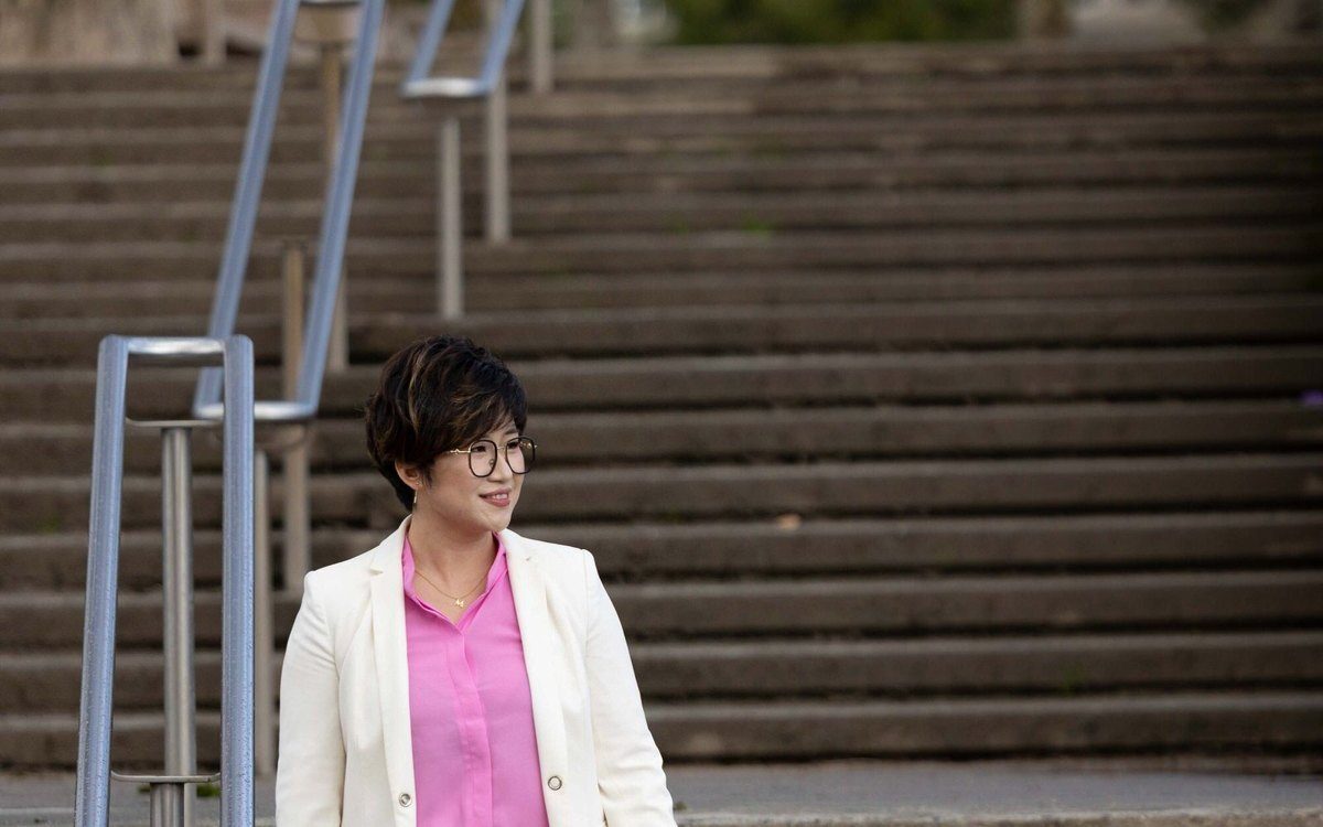 Person standing beside an outdoor stairway