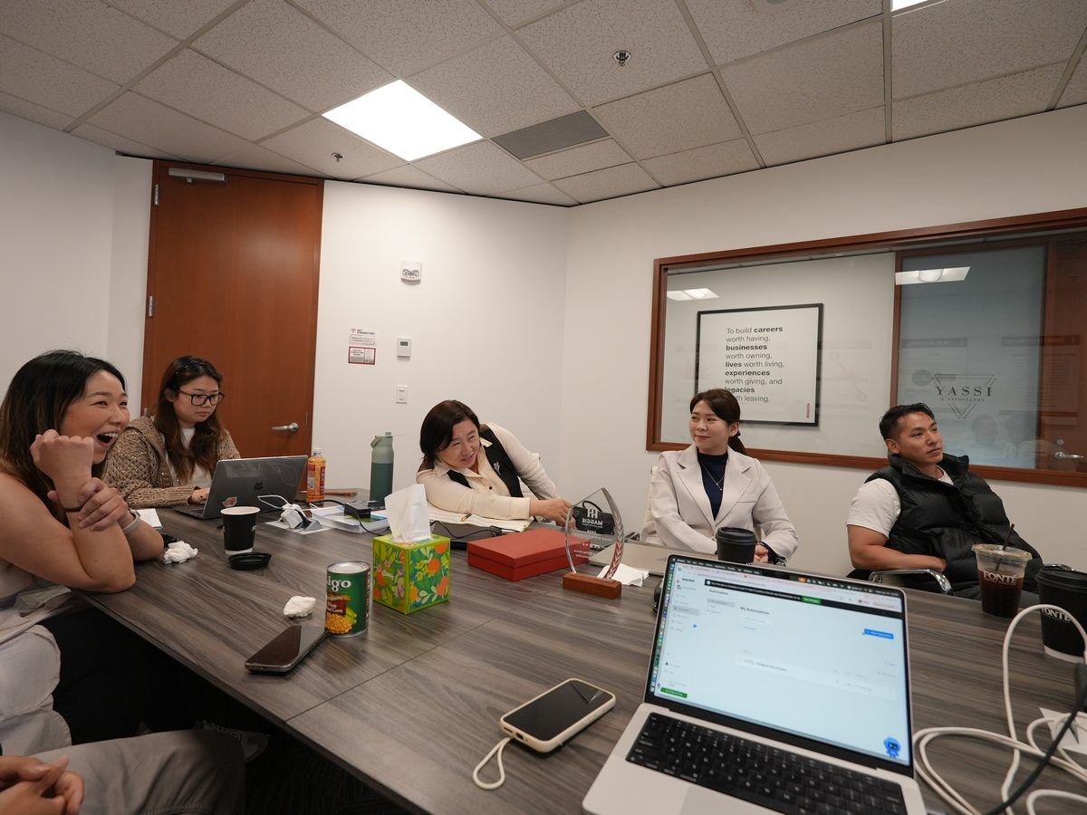 Maggie Sun Real Estate advisors reviewing a home pricing strategy with clients in Bellevue